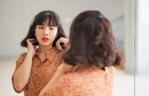 Woman looking in mirror