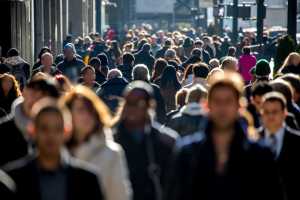 Crowd of people walking through a city