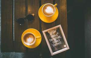 wood table with orange coffee cups