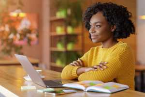 Woman sitting at a computer looking inspired