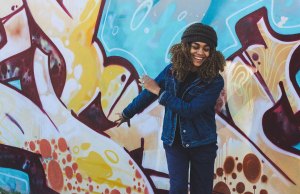 woman in front of graffiti wall