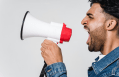 Angry man shouts into bullhorn