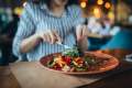 Woman eating salad at a restaurant