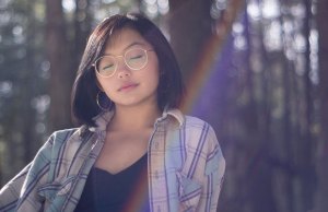 woman closing eyes with rainbow