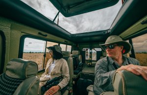 man and woman in safari vehicle