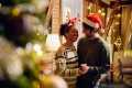 Couple dancing by a Christmas tree