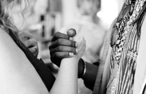 black and white image of two hands holding