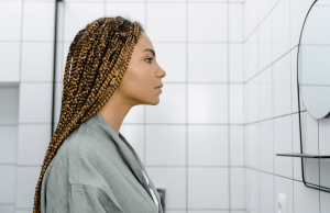 woman looking at herself in mirror