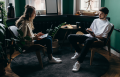 man and woman sitting talking to each other