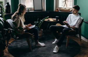 man and woman sitting talking to each other