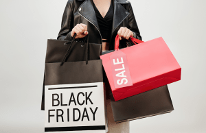 Woman holds multiple shopping bags on Black Friday