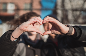 two-people-combine-hands-forming-heart