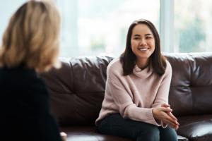 Woman on a couch talking to a therapist