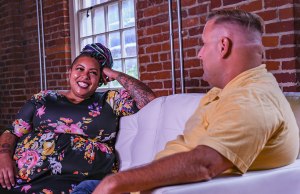 black woman counselor in floral dress and white man counselor in yellow polo