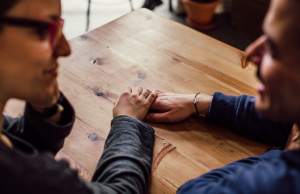 man-and-woman-sitting-together-in-front-of-table