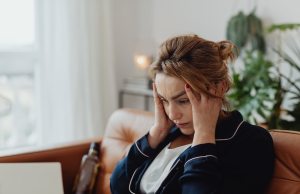 woman-wearing-a-pajama-holding-her-head