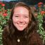 Picture of woman in front of flowers