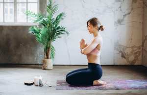 Woman meditating on yoga mat