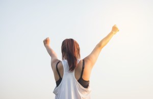 Woman with her fists in the sky