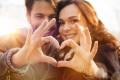 Couple making a heart with hands