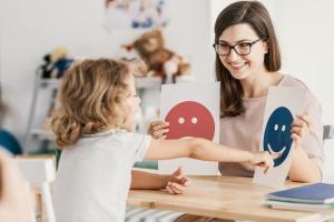 Child being tested using happy and sad faces