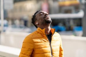 Man tilting head back to feel the sun