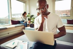 Man sitting and working on a laptop