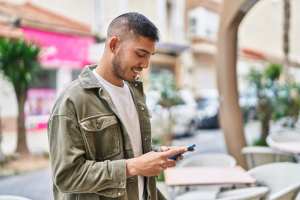 Man smiling and texting